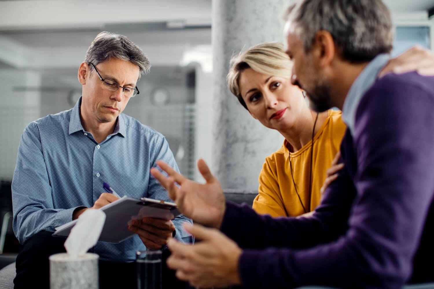 Couples Sharing Concerns Couple discussing their issues with a therapy expert at Therapy Brampton