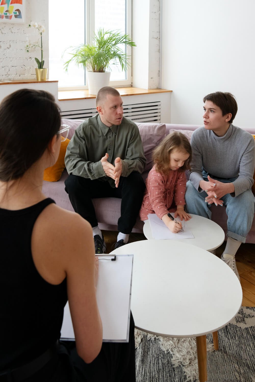 2149305210 Smiling family participating in a therapy session